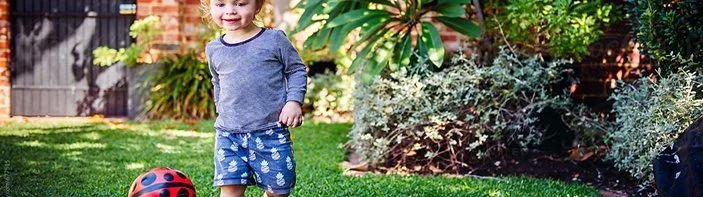child playing in backyard